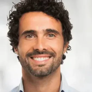 Smiling man holding a supplement bottle
