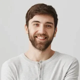 Smiling man holding a supplement bottle